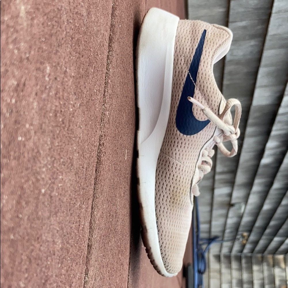 These are some girls pink and blue Nike shoes.